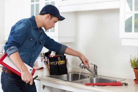 man looking at taps