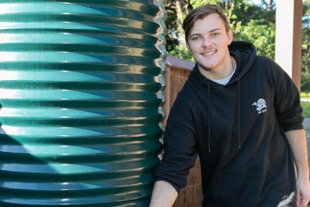 man using rainwater tank